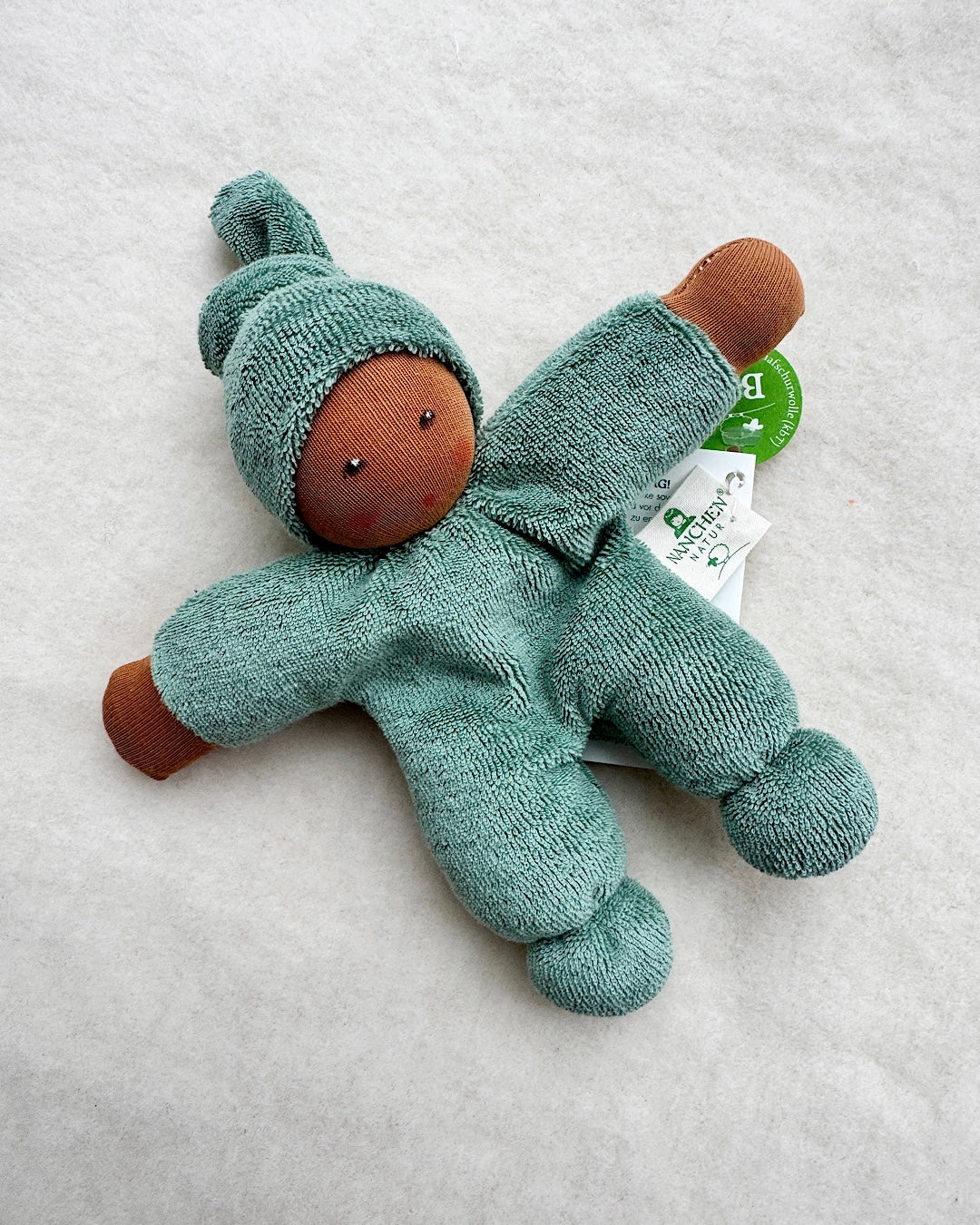 Håndsyet økologisk dukke - lys turkis